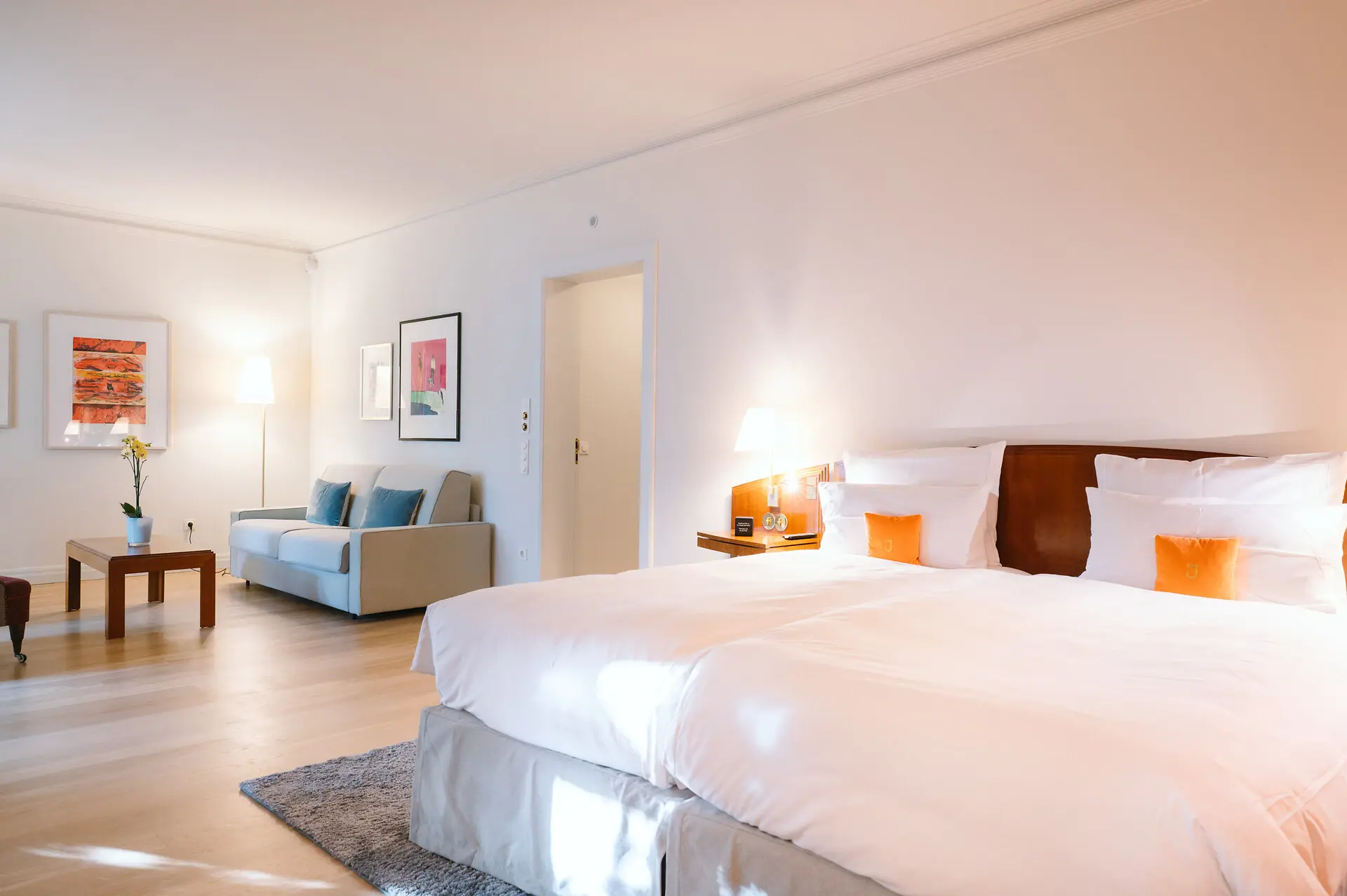 Studio Louis C. Jacob Hotel Hamburg Ein großes Hotelzimmer mit einem Bett und einem Sofa.