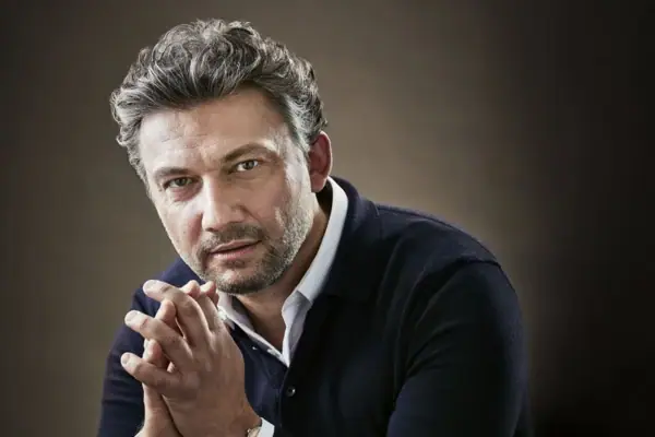 Jonas Kaufmann Porträtbild von Jonas Kaufmann mit gefalteten Händen.