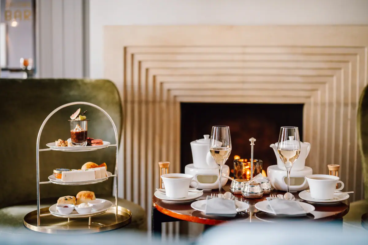 Afternoon Tea Ein Tisch mit Tischgeschirr und Speisen darauf.